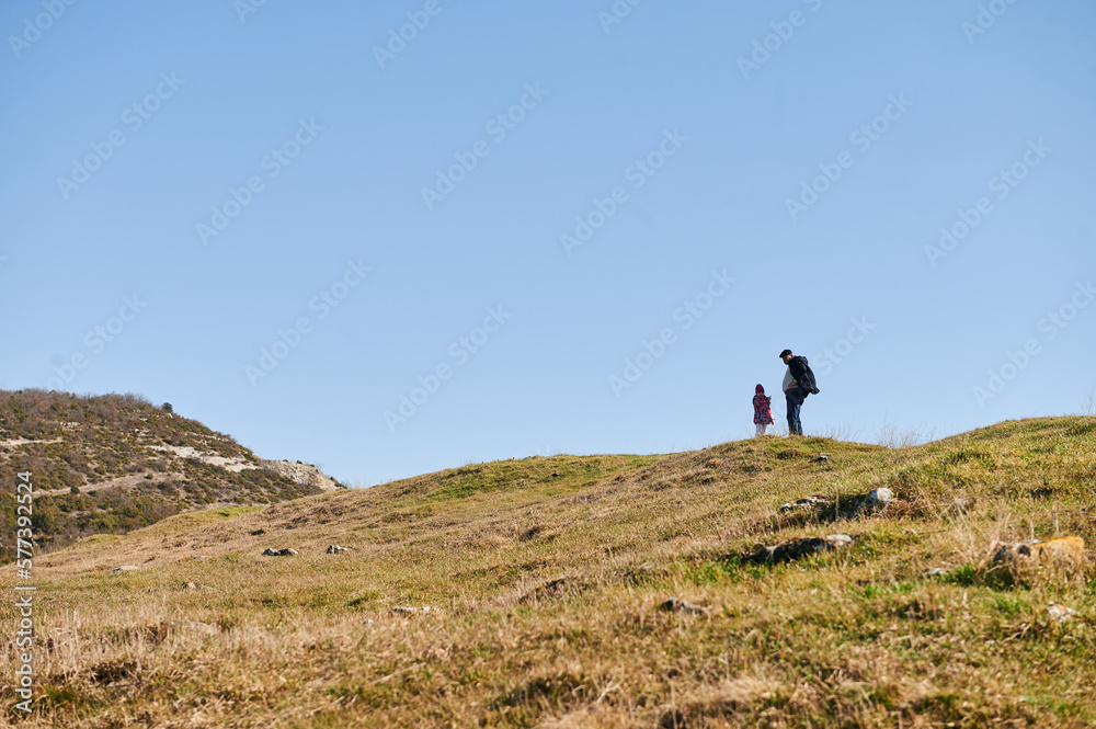 Grandfather and grandson on hill