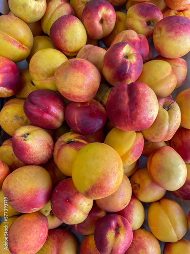 lots of ripe peach nectarines healthy food fruits as background