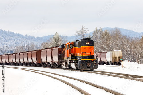 freight train in winter with lead locomotive reversed close to Whitefish, Montana