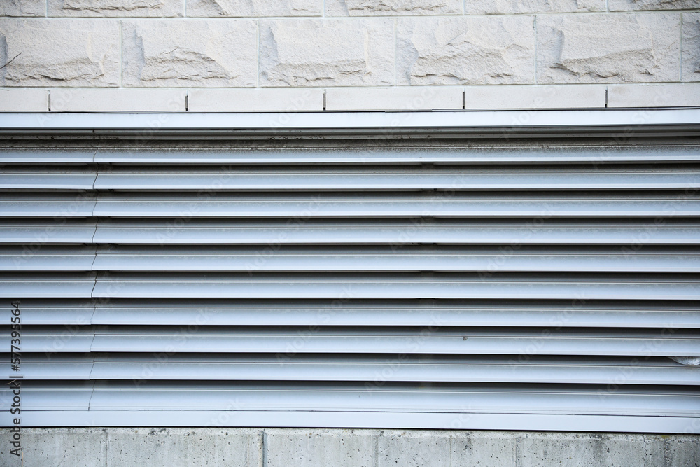 air vent and air conditioner grill outdoor system circulating dusty air in urban setting