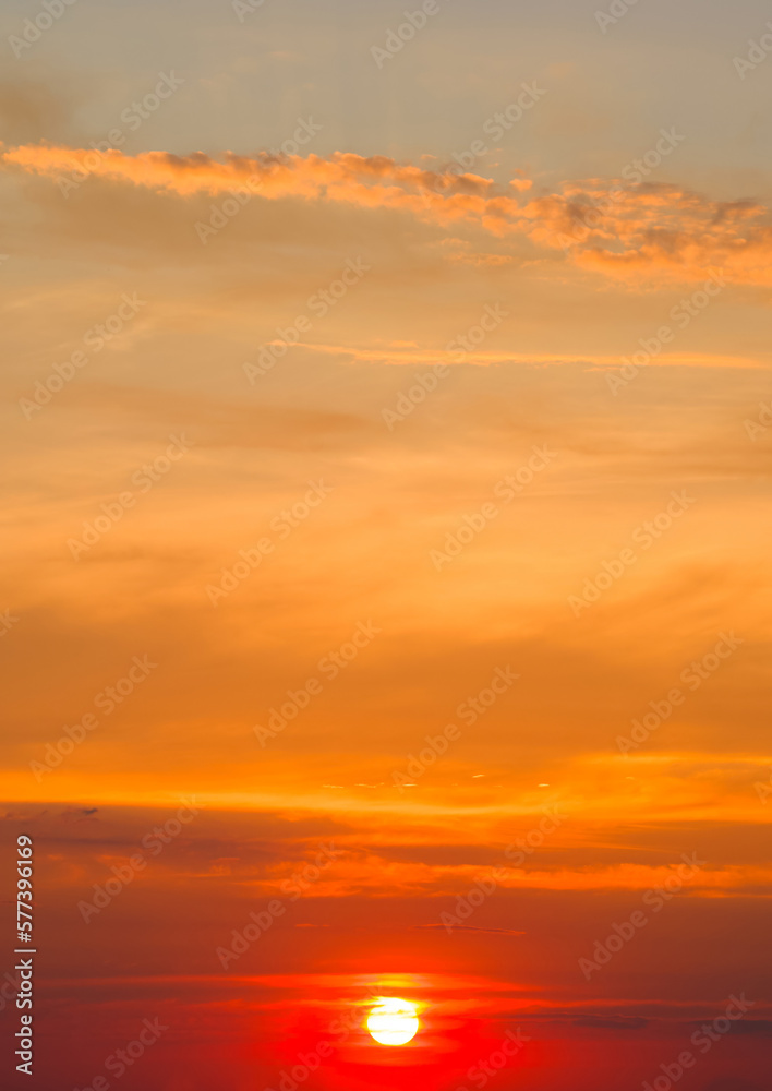 Bright red sunrise on the blue sky. Vertical photo.