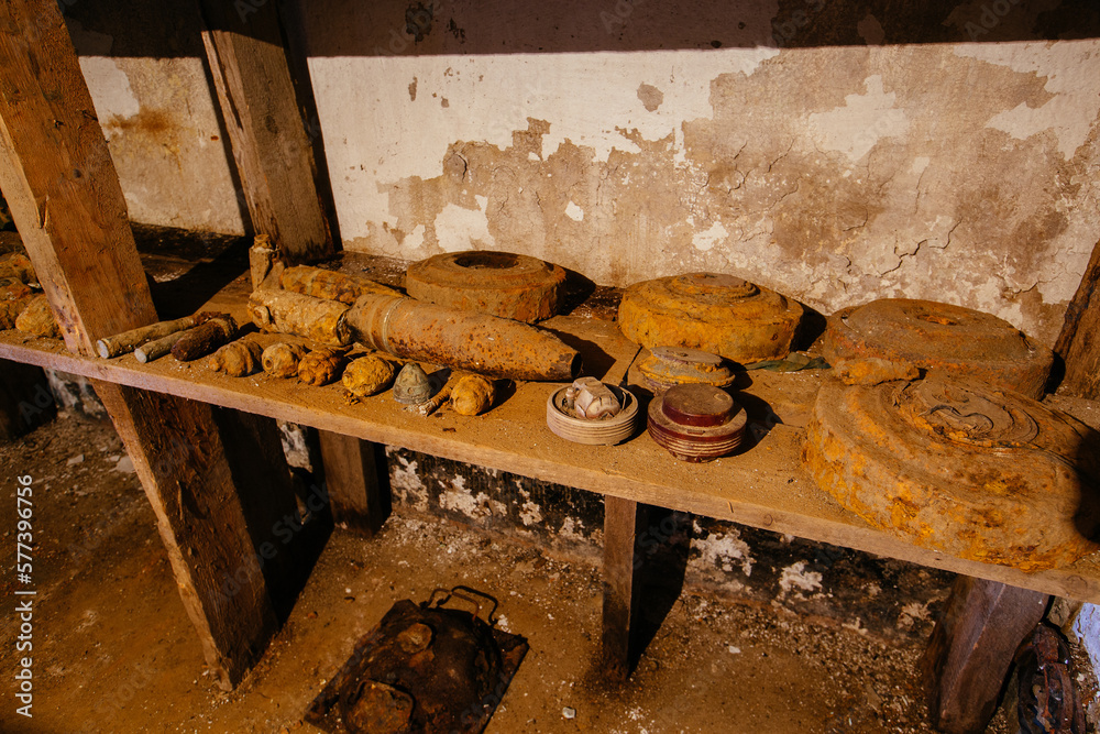 Old rusty ammo, tank shells, mines and grenades, dug out after demining