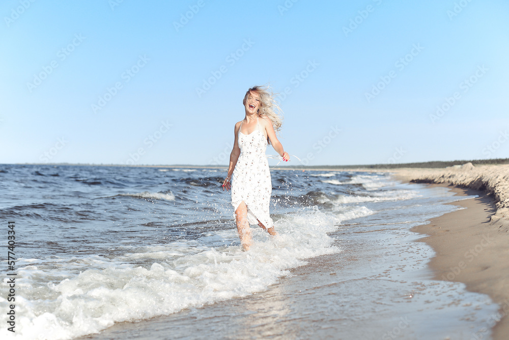 Happy blonde beautiful woman having fun on ocean beach while dancing in waves. Happy blonde beautiful woman having fun on ocean beach while dancing in waves.