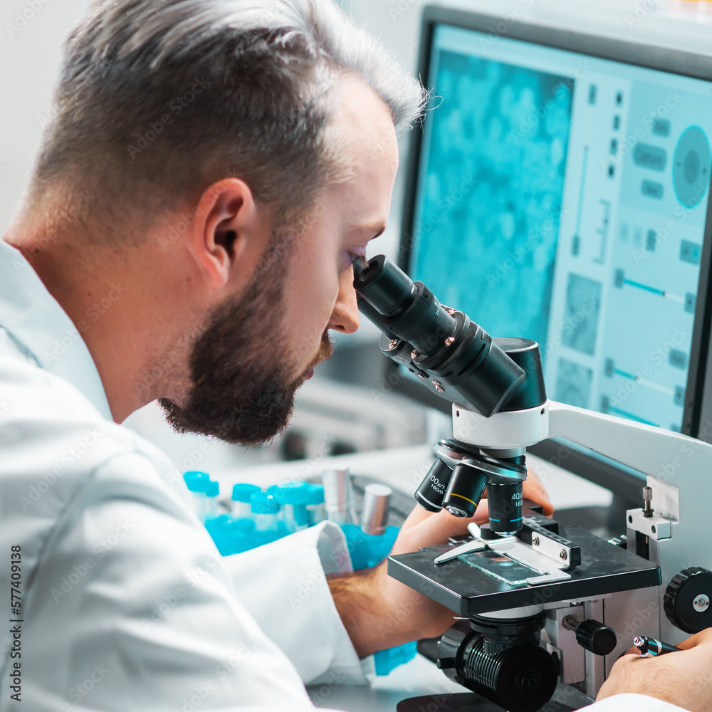 Professional scientist is working on a vaccine in a modern scientific research laboratory. Genetic engineer workplace. Future technology and science. Professional scientist is working on a vaccine in a modern scientific research laboratory. Genetic engineer workplace. Future technology and science.