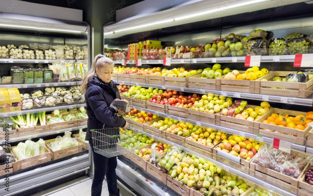 Woman buying fruits and vegetables at the market