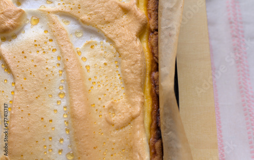 Top view of homemade freshly baked cheesecake with dew. Appetizing background showing a close-up of a browned meringue with precipitated droplets of melted sugar. copy space.