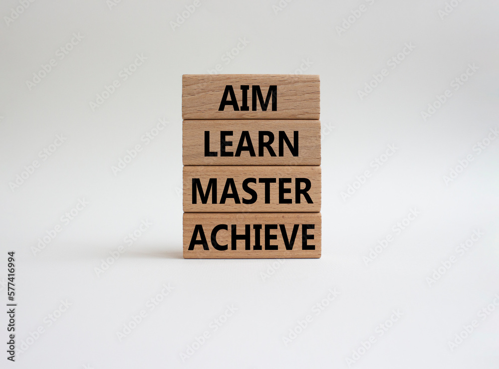Aim Learn Master Achieve symbol. Concept word Aim Learn Master Achieve on wooden blocks. Beautiful white background. Business and Aim Learn Master Achieve concept. Copy space Aim Learn Master Achieve symbol. Concept word Aim Learn Master Achieve on wooden blocks. Beautiful white background. Business and Aim Learn Master Achieve concept. Copy space