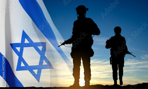 Silhouettes of soldiers with Israel flag against the sunrise. Concept - Armed forces of Israel. EPS10 vector photo