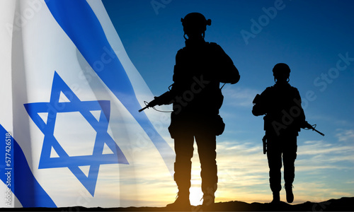 Silhouettes of soldiers with Israel flag against the sunrise. Concept - Armed forces of Israel. EPS10 vector