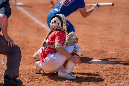 Fastpitch softball catcher waiting for pitch with batter showing bunt.
 photo