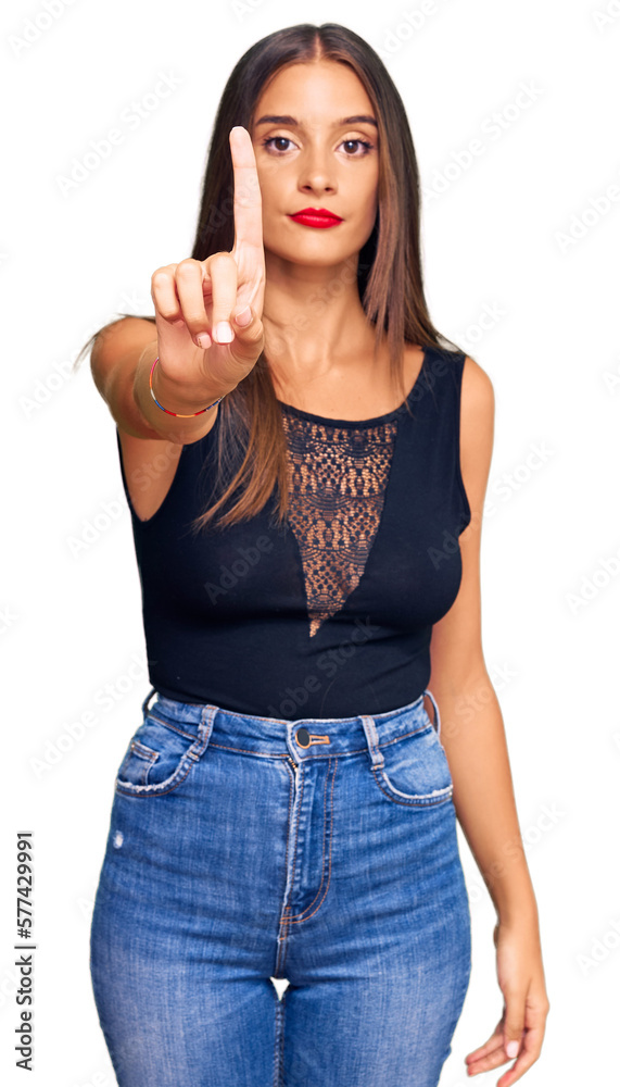 Young hispanic woman wearing casual clothes pointing with finger up and angry expression, showing no gesture Young hispanic woman wearing casual clothes pointing with finger up and angry expression, showing no gesture