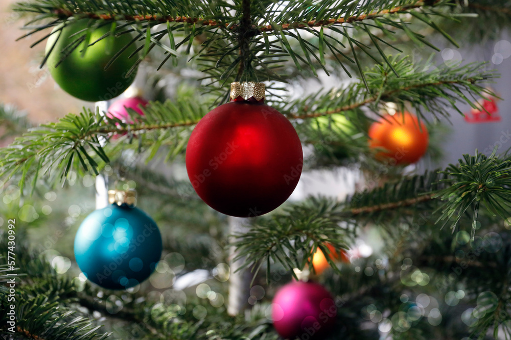 Lots of colorful Christmas baubles on the Christmas tree, close up.