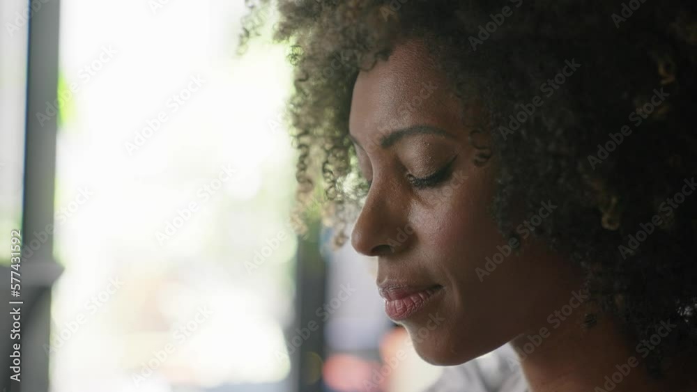 African american woman face closeup. Thoughtful professional looking down. Close up confident. Business woman portrait with natural makeup. Real pensive businesswoman thinking

