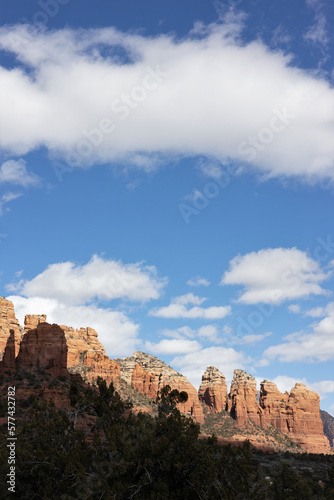 Red rocks and a blue sky with puffy white clouds, in Sedona, Arizona.