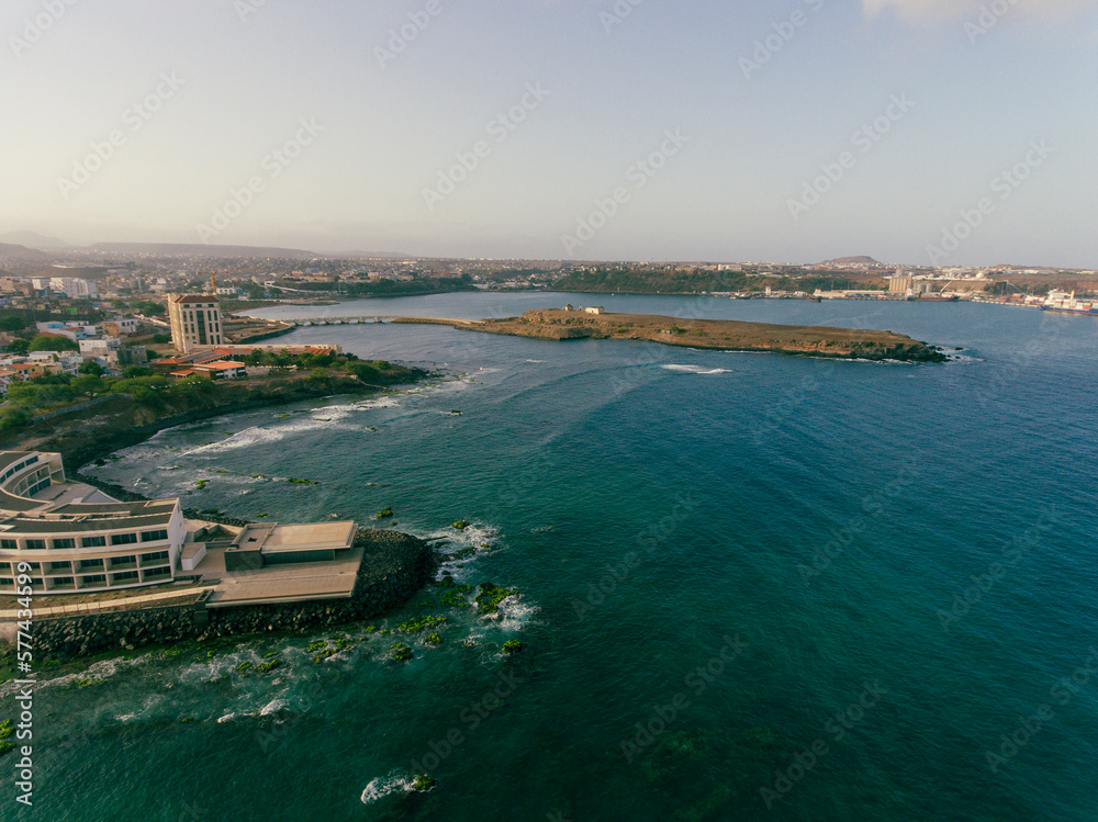 Aerial photos of Farol da Praia in Santiago, Cape Verde showcase a stunning lighthouse on a rugged coastline with breathtaking views of the Atlantic Ocean, surrounded by dramatic cliffs, sandy beaches