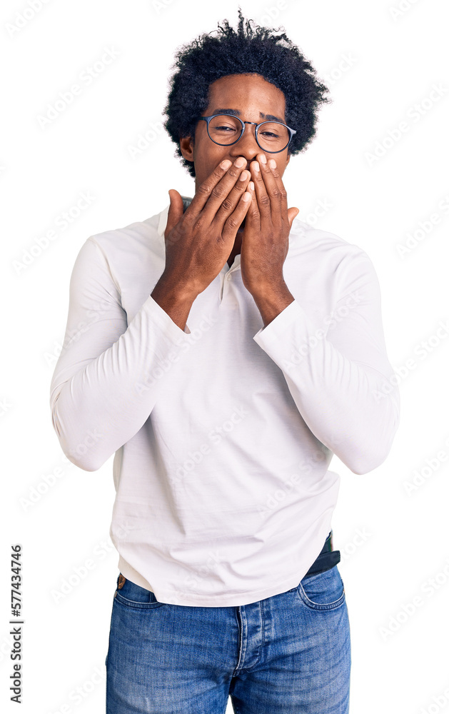 Handsome african american man with afro hair wearing casual clothes and glasses laughing and embarrassed giggle covering mouth with hands, gossip and scandal concept Handsome african american man with afro hair wearing casual clothes and glasses laughing and embarrassed giggle covering mouth with hands, gossip and scandal concept