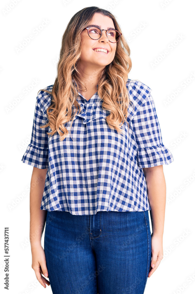 Young caucasian woman wearing casual clothes looking away to side with smile on face, natural expression. laughing confident. Young caucasian woman wearing casual clothes looking away to side with smile on face, natural expression. laughing confident.
