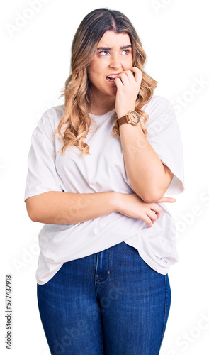 Young caucasian woman wearing casual clothes looking stressed and nervous with hands on mouth biting nails. anxiety problem. © Krakenimages.com