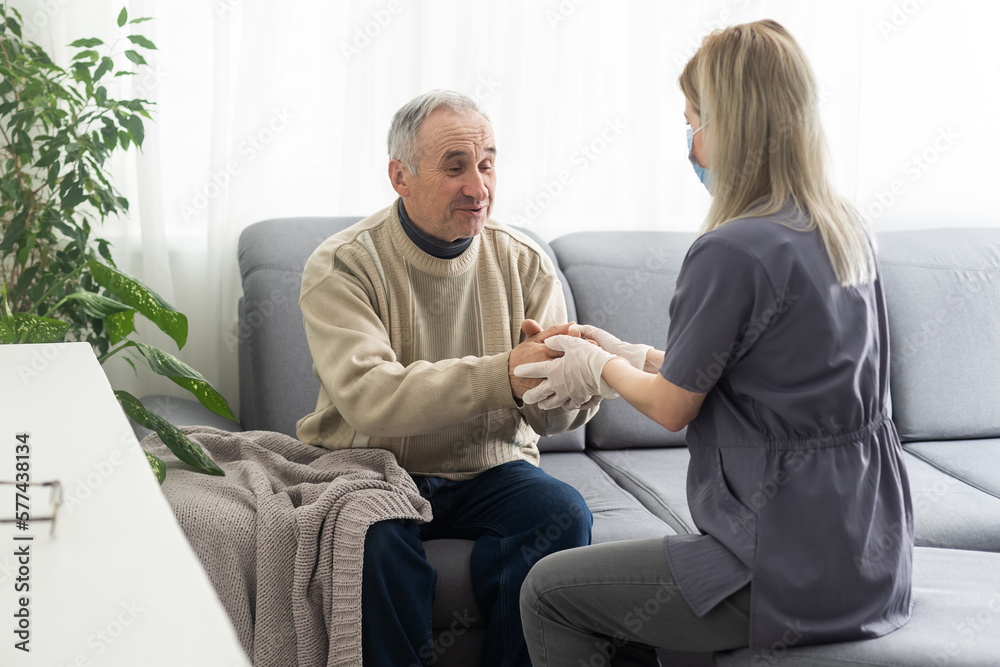 Kind female doctor embracing encouraging senior male patient in hospital. Happy healthy older man and his physician enjoying talking at nursing home. Elderly medical health care concept. Kind female doctor embracing encouraging senior male patient in hospital. Happy healthy older man and his physician enjoying talking at nursing home. Elderly medical health care concept.