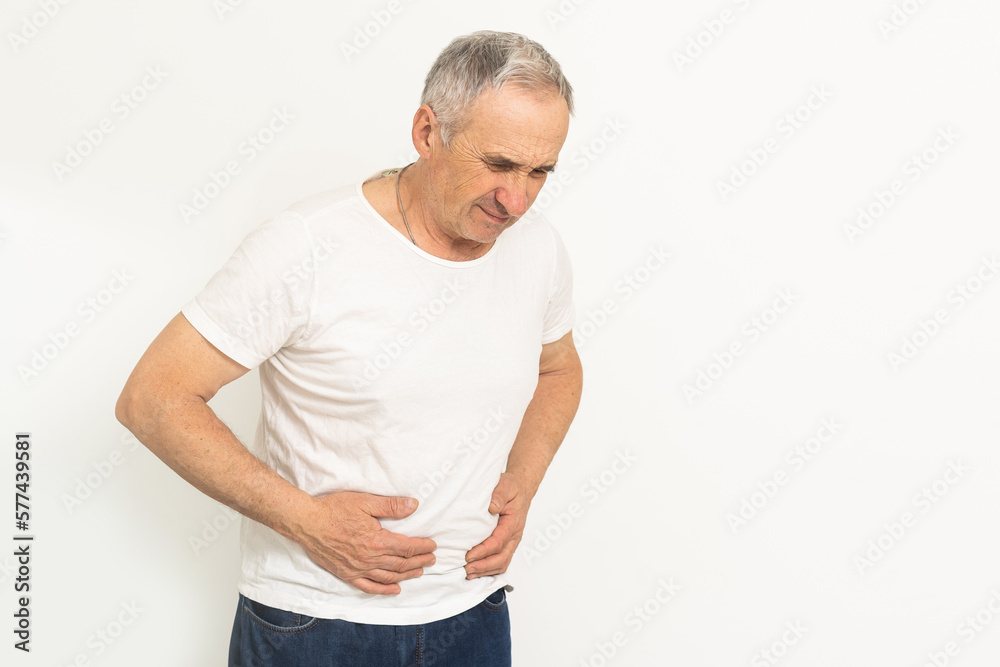 Senior man having stomach pain sitting at home. Senior man having stomach pain sitting at home.