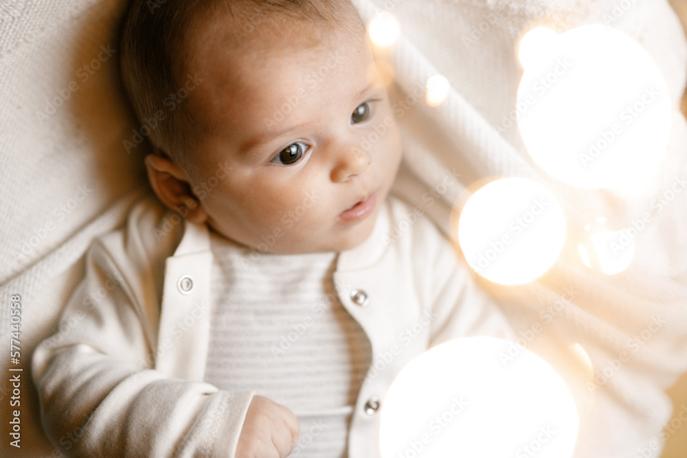 Adorable baby in bedroom. Little girl is resting in crib. Smiling child playing in crib before going to bed. Child looking at the camera. Adorable baby in bedroom. Little girl is resting in crib. Smiling child playing in crib before going to bed. Child looking at the camera.