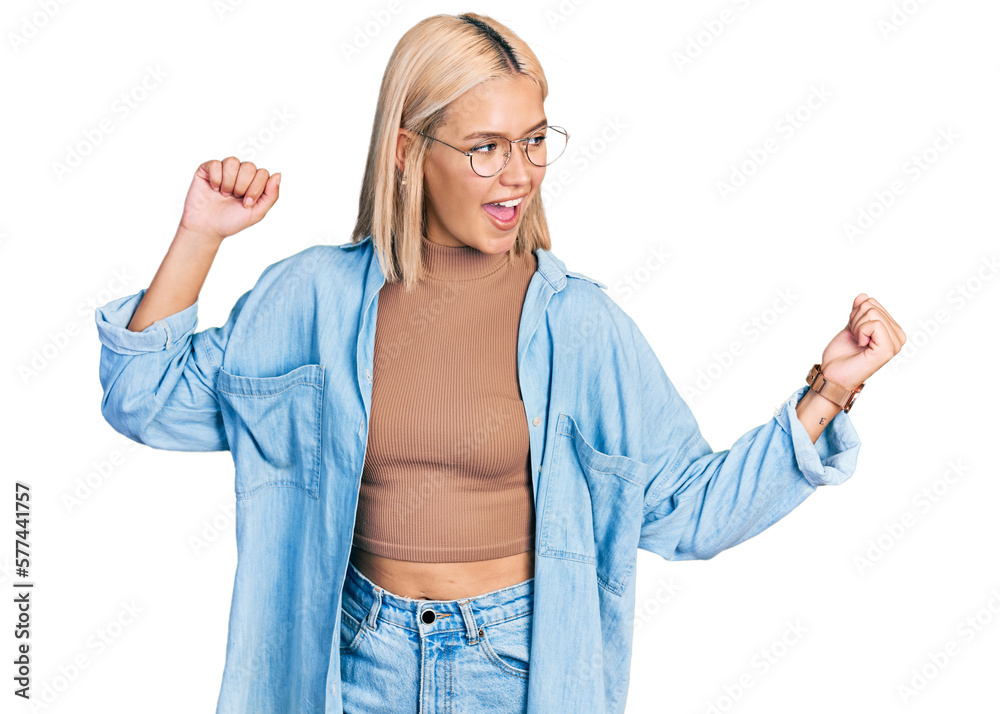Beautiful young blonde woman wearing glasses dancing happy and cheerful, smiling moving casual and confident listening to music Beautiful young blonde woman wearing glasses dancing happy and cheerful, smiling moving casual and confident listening to music