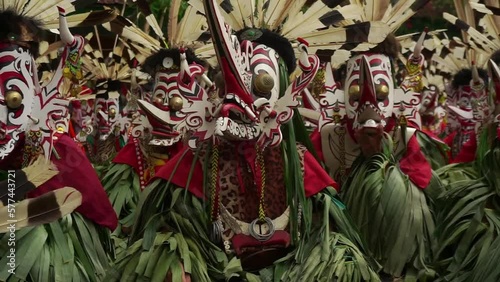 the scene of hudoq dancers marching in order to perform sacred rituals performed by indigenous tribes   photo