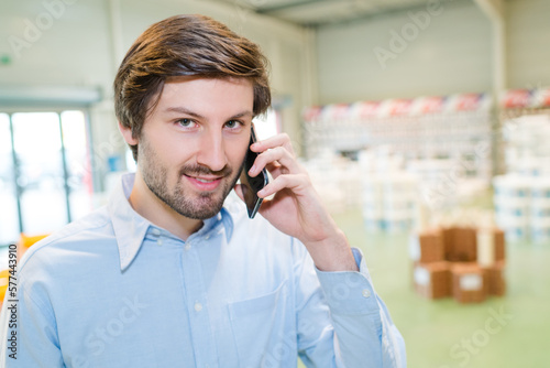 happy man on phone in a storage area