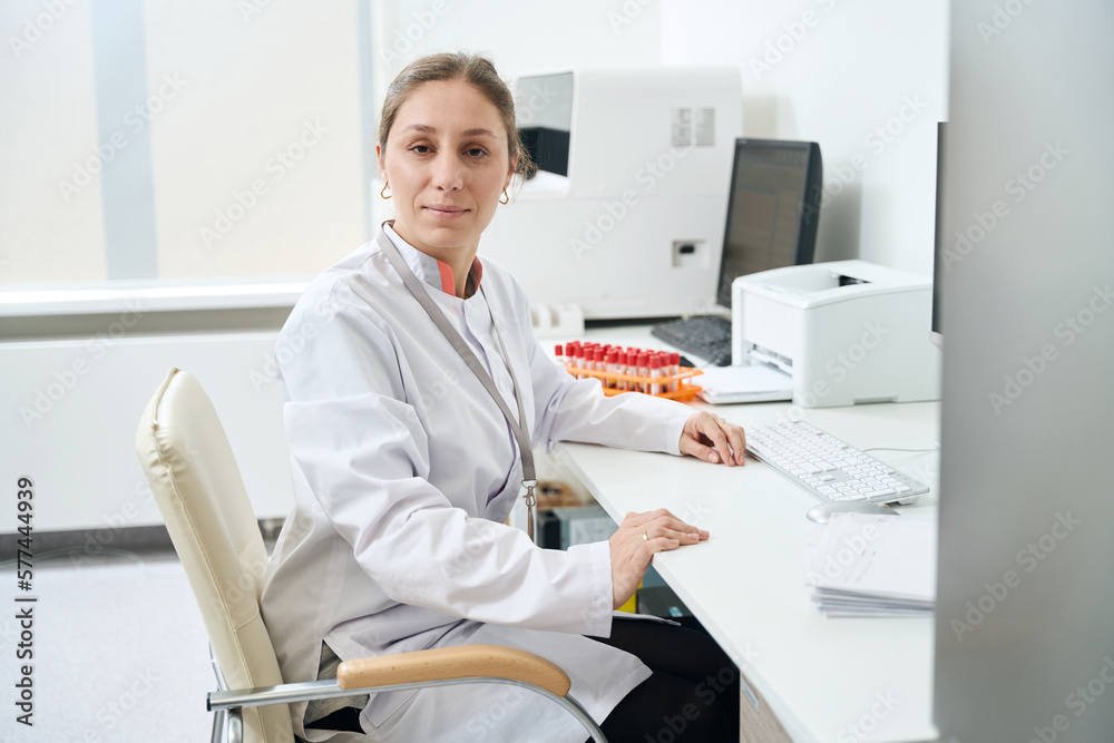Laboratory employee is sitting at her desk Laboratory employee is sitting at her desk
