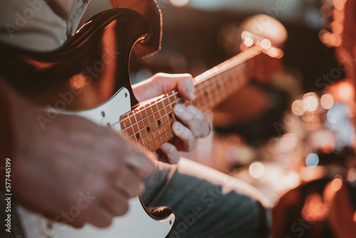 Man playing the electric guitar, no faces shown