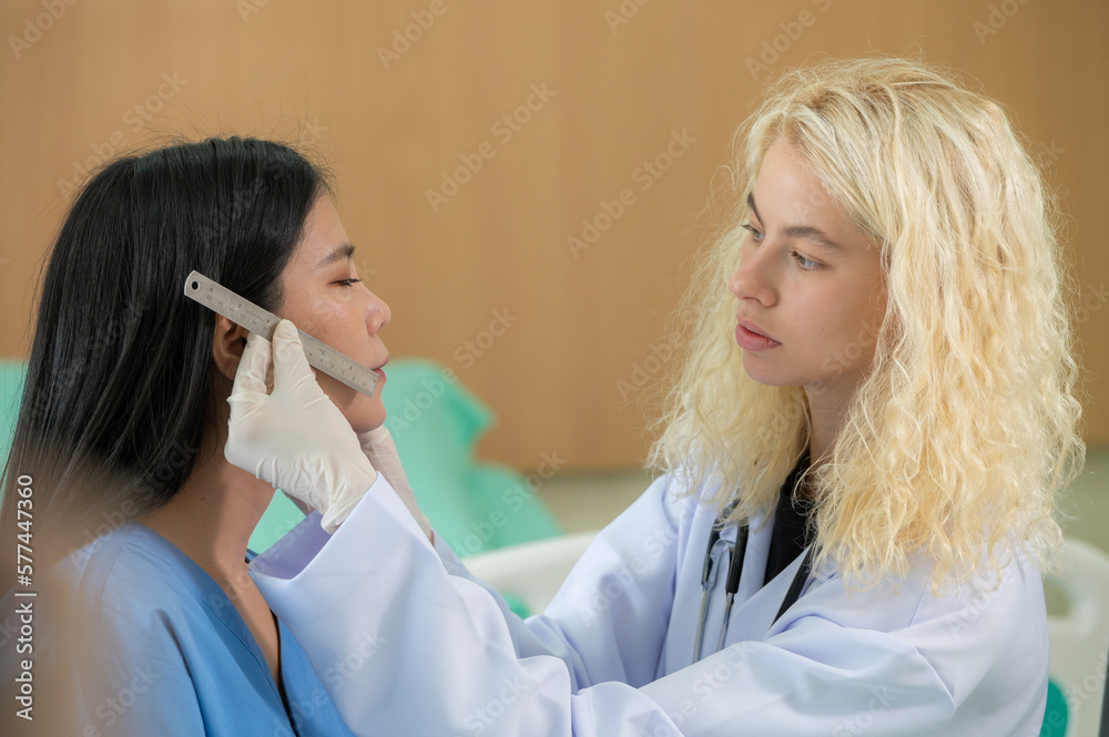 Woman doctors use ruler measure patient face skin check before filler botox surgery. Beautician use touching woman face for diagnosis therapy skin care improvement. Woman doctors use ruler measure patient face skin check before filler botox surgery. Beautician use touching woman face for diagnosis therapy skin care improvement.