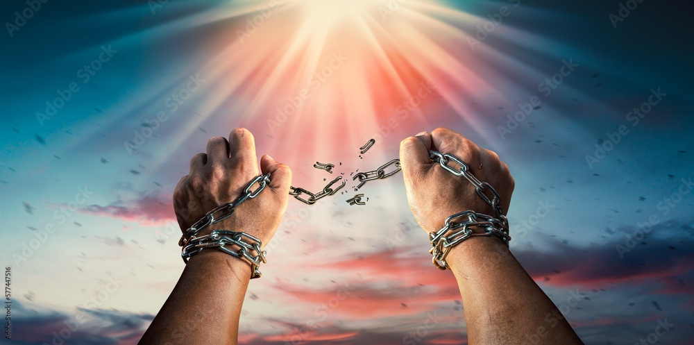 Hands in fists breaking a chain freedom. The concept of gaining freedom ...
