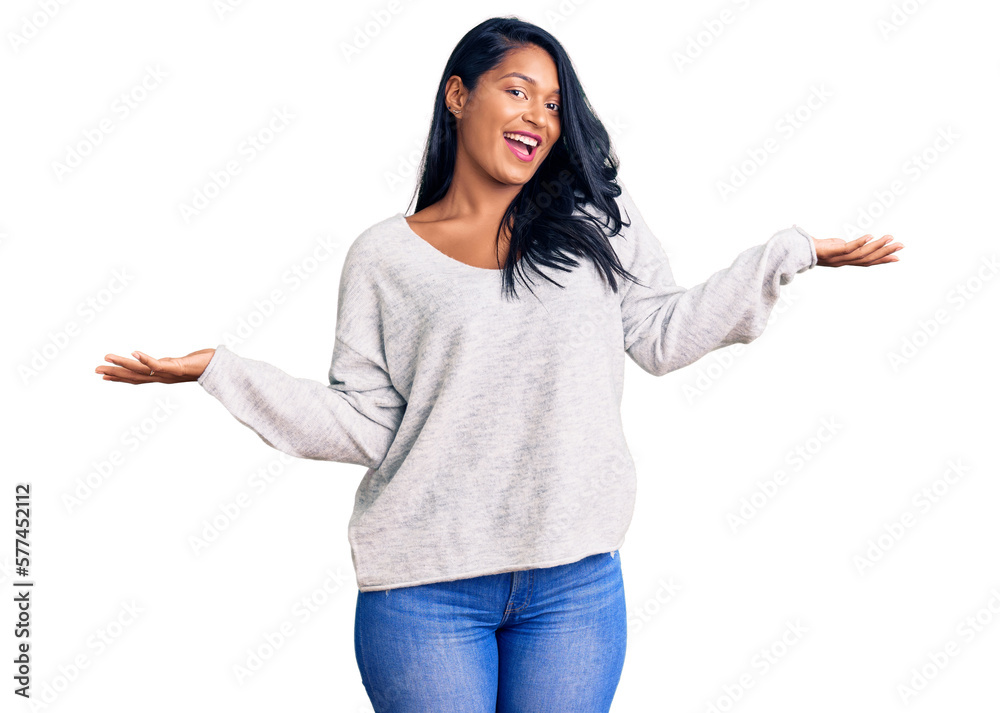 Hispanic woman with long hair wearing casual clothes smiling showing both hands open palms, presenting and advertising comparison and balance Hispanic woman with long hair wearing casual clothes smiling showing both hands open palms, presenting and advertising comparison and balance