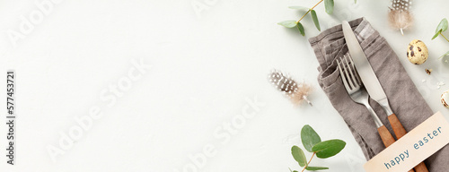 Photography Easter composition, table setting with vintage cutlery, easter eggs and spring b