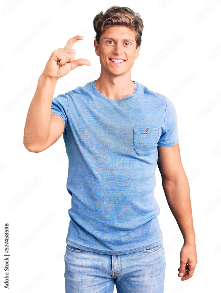 Young handsome man wearing casual clothes smiling and confident gesturing with hand doing small size sign with fingers looking and the camera. measure concept. Young handsome man wearing casual clothes smiling and confident gesturing with hand doing small size sign with fingers looking and the camera. measure concept.