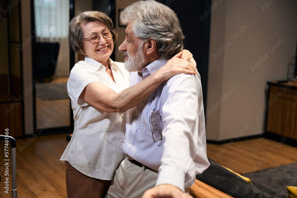 Fototapeta premium Elderly woman and male arrived at hotel after trip