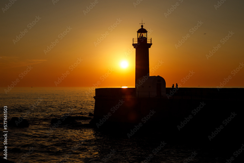 Ocean lighthouse at the sunset.
