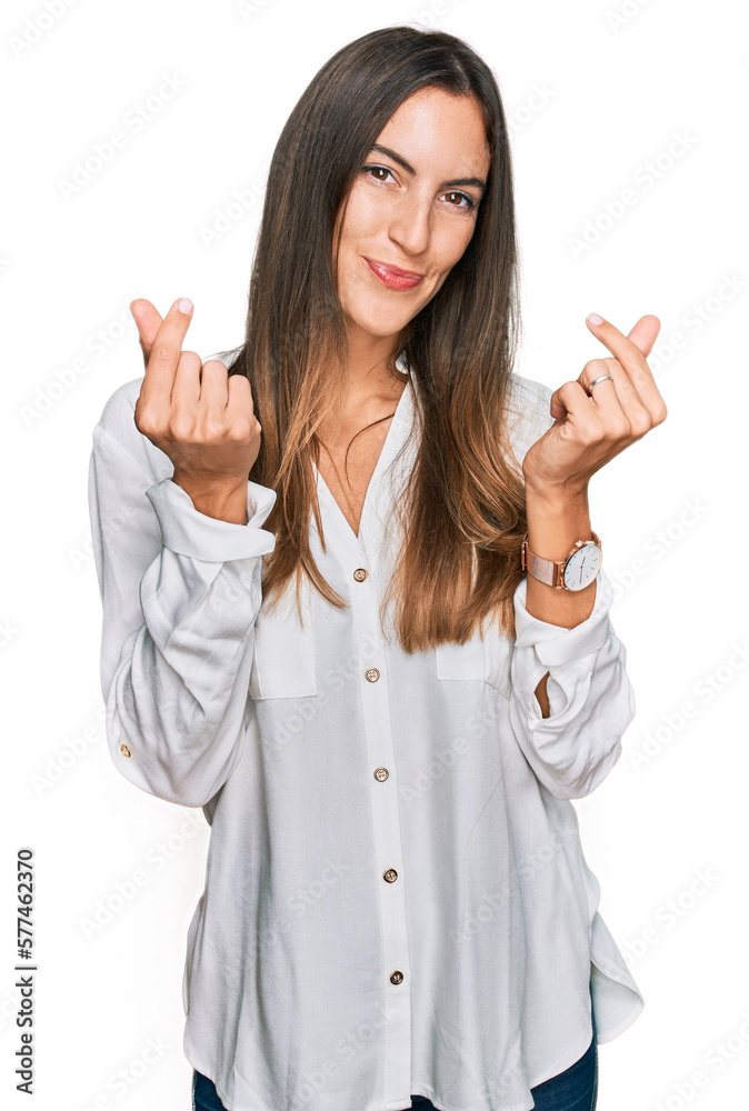 Young beautiful woman wearing casual clothes doing money gesture with hands, asking for salary payment, millionaire business Young beautiful woman wearing casual clothes doing money gesture with hands, asking for salary payment, millionaire business