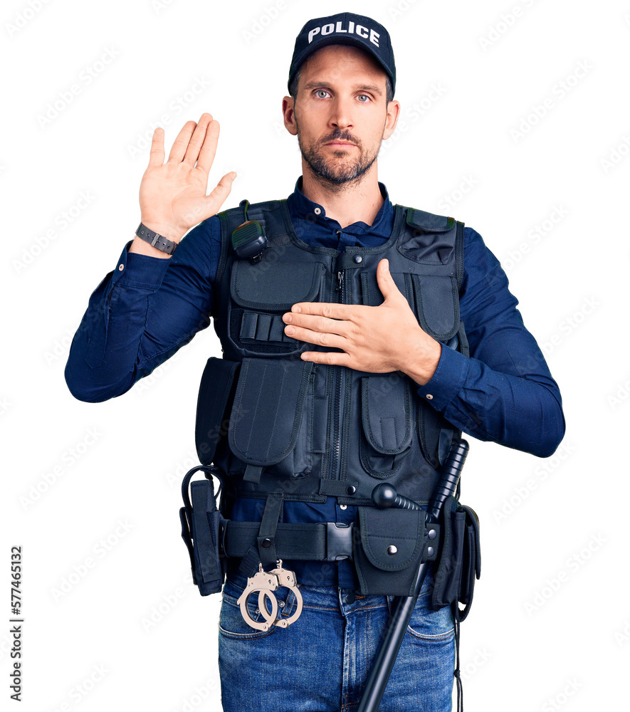 Young handsome man wearing police uniform swearing with hand on chest and open palm, making a loyalty promise oath Young handsome man wearing police uniform swearing with hand on chest and open palm, making a loyalty promise oath
