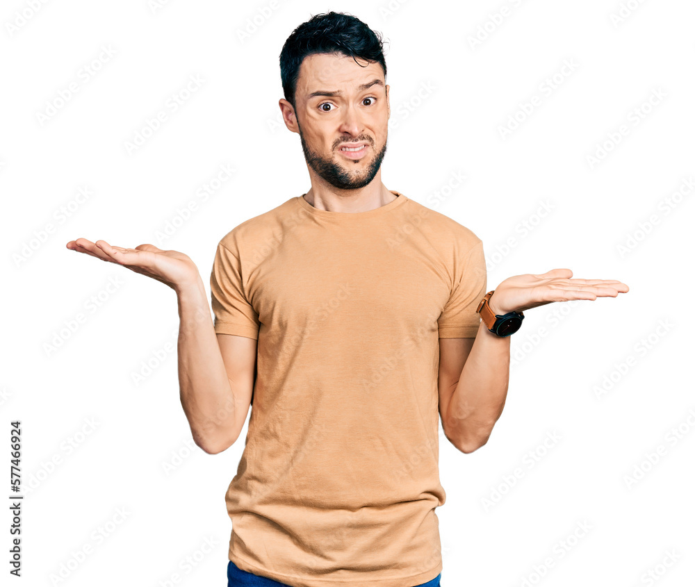 Hispanic man with beard wearing casual t shirt clueless and confused with open arms, no idea concept. Hispanic man with beard wearing casual t shirt clueless and confused with open arms, no idea concept.