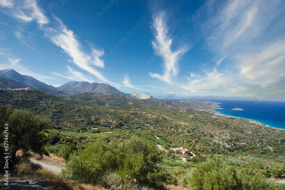 greek island crete in the mediterranean sea. view over the landscape with mountains and coast. clouds with sun.