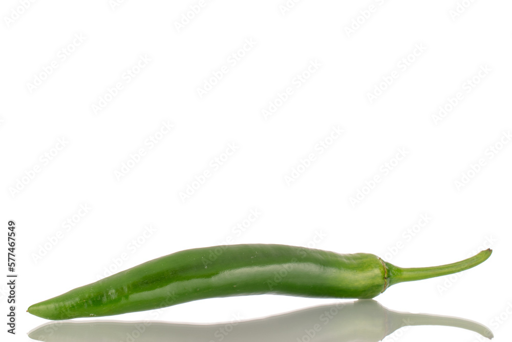 One green spicy pepper, macro, isolated on a white background. One green spicy pepper, macro, isolated on a white background.