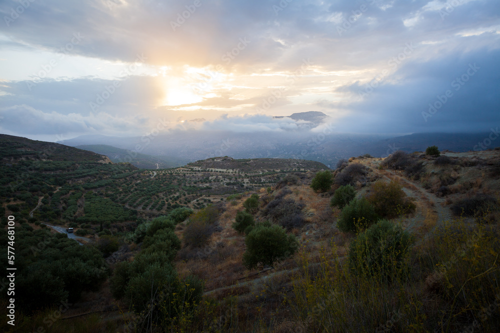 greek landscape on island crete with mountain range and country side, clouds and sundown. greek landscape on island crete with mountain range and country side, clouds and sundown.
