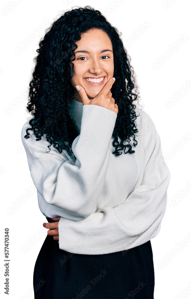 Young hispanic woman with curly hair wearing casual sweater looking confident at the camera smiling with crossed arms and hand raised on chin. thinking positive. Young hispanic woman with curly hair wearing casual sweater looking confident at the camera smiling with crossed arms and hand raised on chin. thinking positive.
