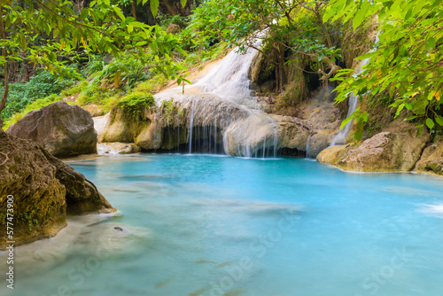 Waterfall in tropical landscape, green trees in wild jungle forest. Erawan National park, Kanchanaburi, Thailand