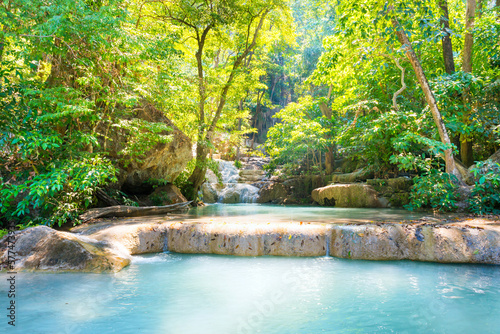 Waterfall in tropical landscape, green trees in wild jungle forest