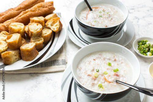 Beef Squid Pork congee with Youtiao, also known as Chinese fried dough or Chinese crullers, is a breakfast favorite in China.	
