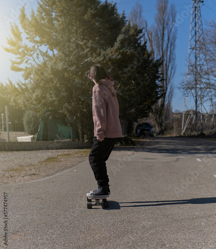 girl skateboarding down the street