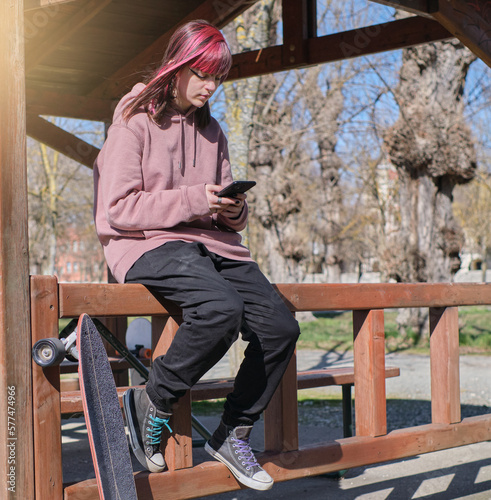 girl using a cell phone in a skate park
