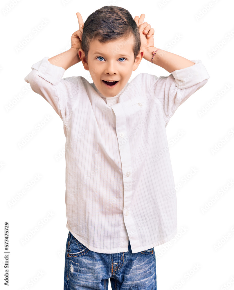 Cute blond kid wearing elegant shirt posing funny and crazy with fingers on head as bunny ears, smiling cheerful Cute blond kid wearing elegant shirt posing funny and crazy with fingers on head as bunny ears, smiling cheerful